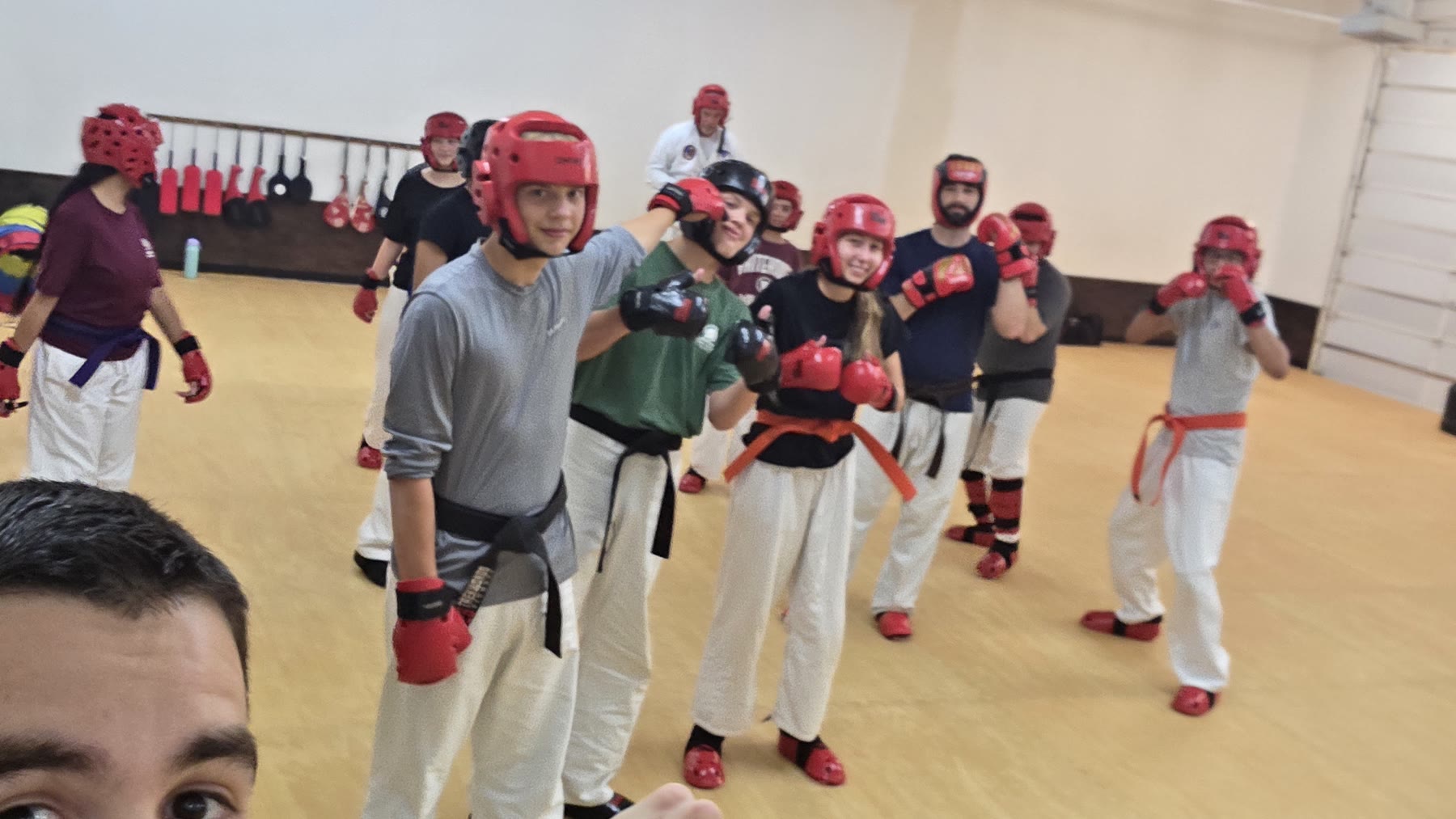 Teens and adults in sparring gear lined up during class at Bares Taekwondo Fitness in Tyler, TX