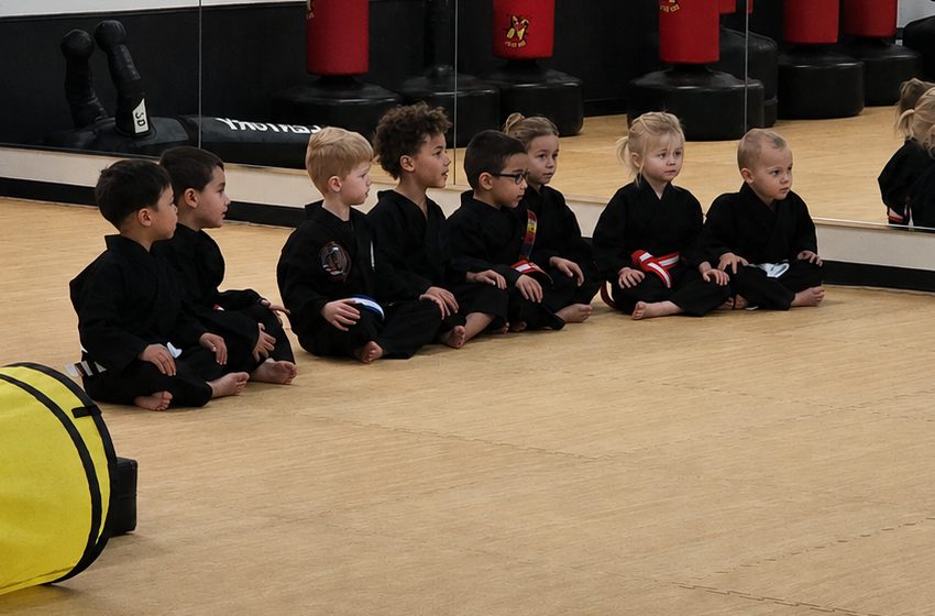 Young Cubs students in uniform sitting on the mat during class at Bares Taekwondo Fitness in Tyler, TX