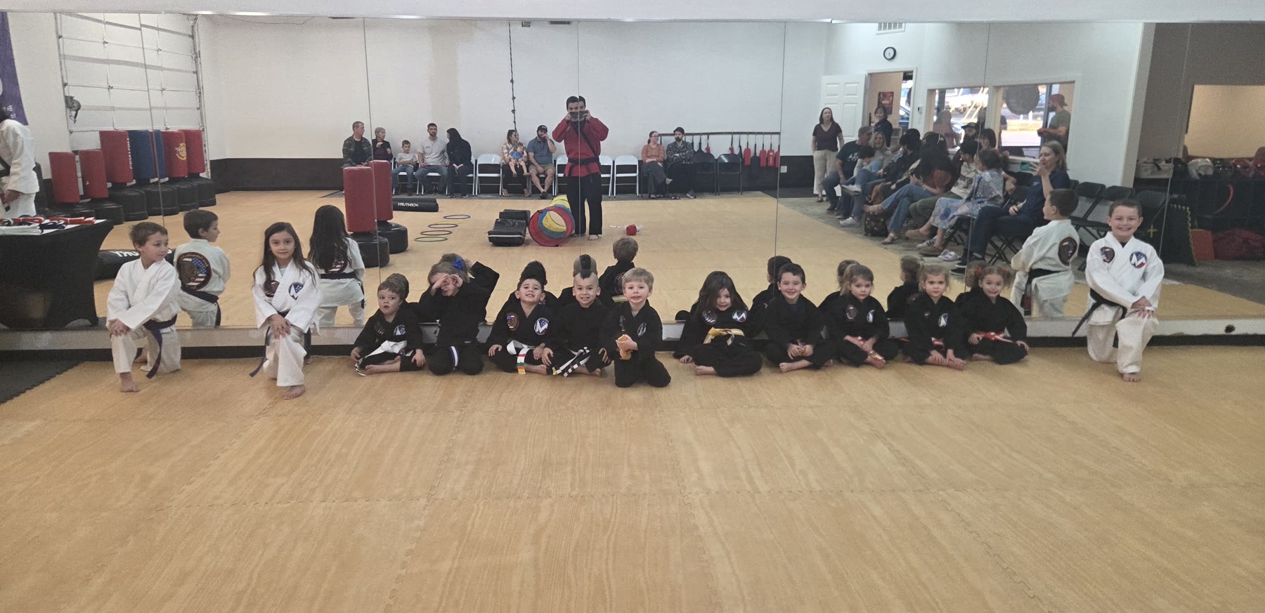 The Cubs class lined up on the mat under the flags at Bares Taekwondo Fitness in Tyler, TX
